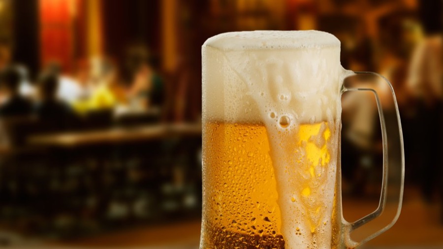 A cold draft beer poured into a frosted mug
